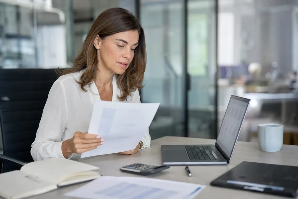 Talent acquisition manager comparing a video interview software quote with a cost spreadsheet